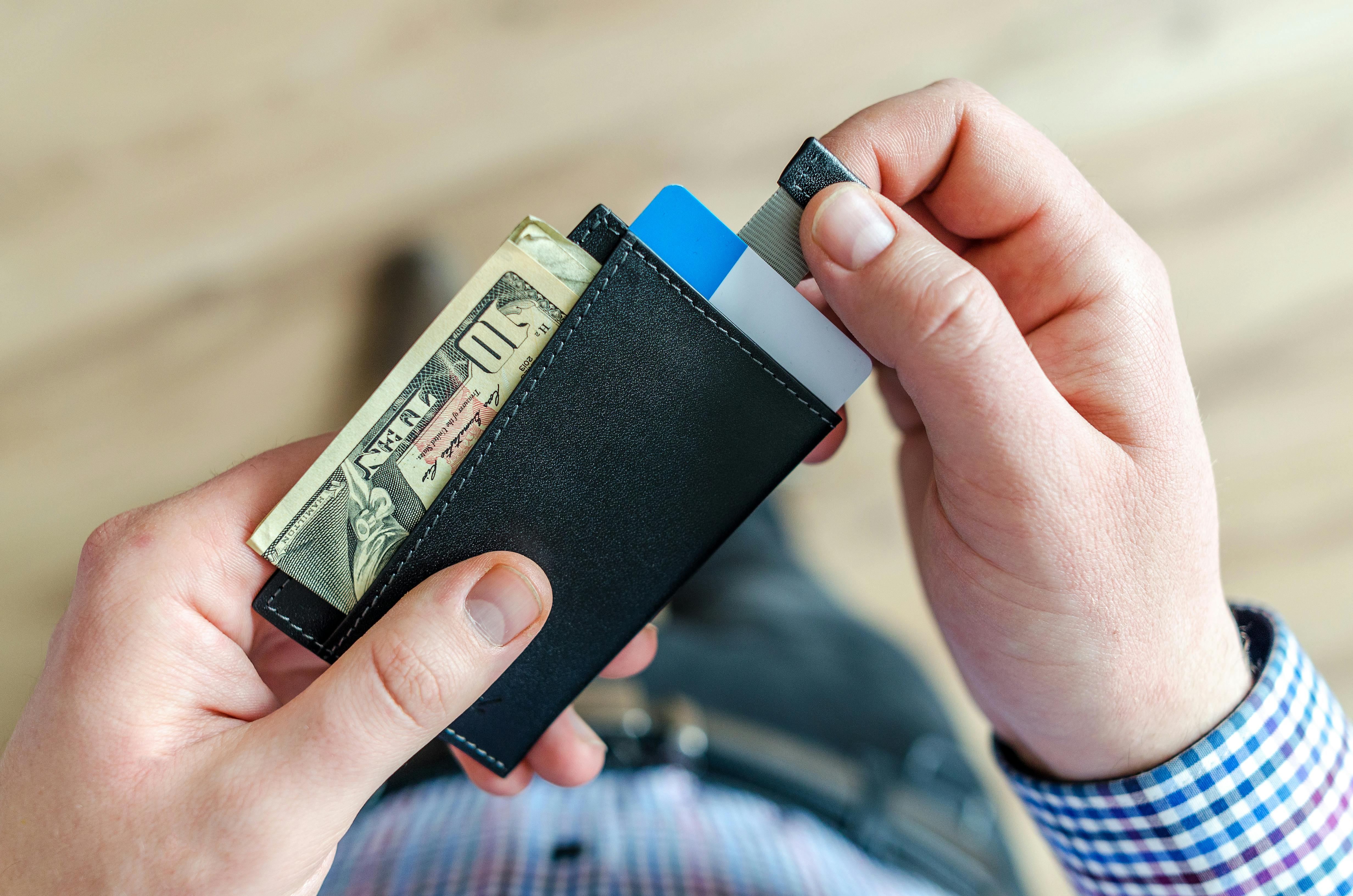 person holding black card holder