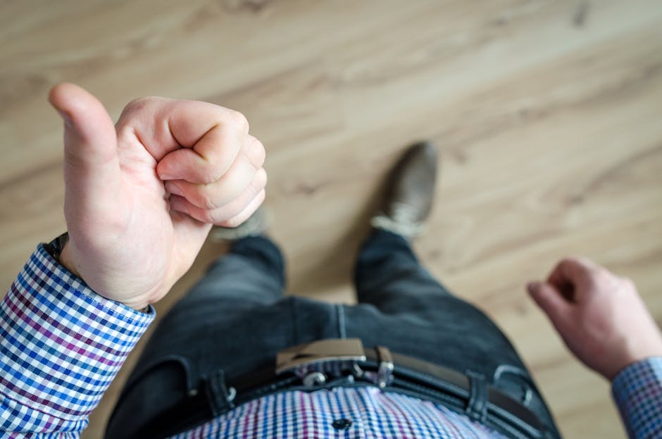 Person Showing His Left Thumb