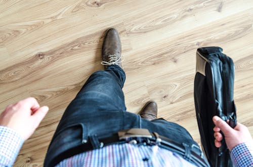 Man Walking Holding Leather Bag