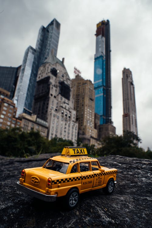Toy Taxi and Skyscrapers in Background