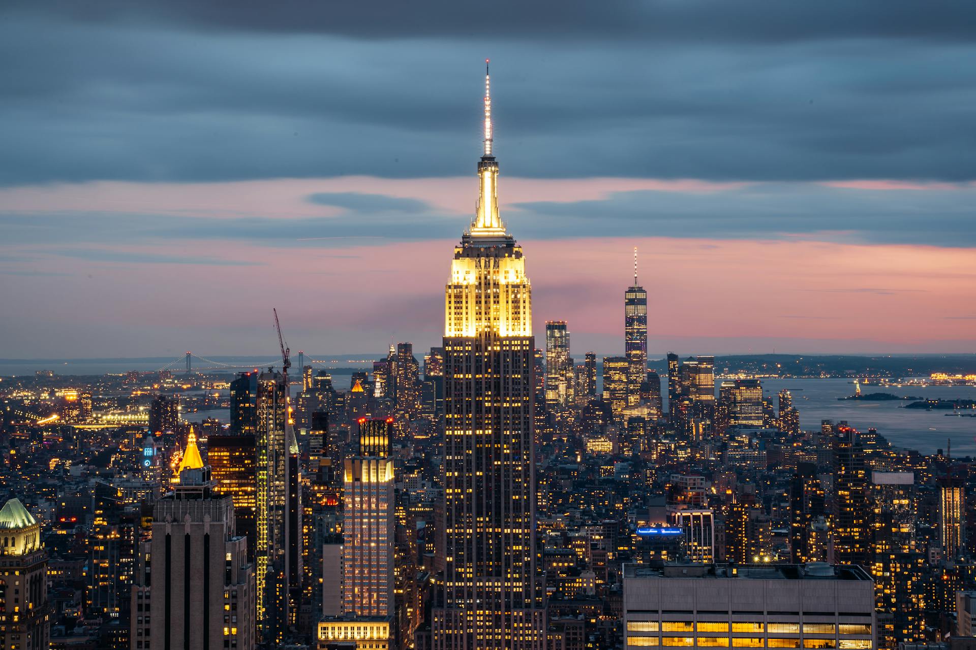 Breathtaking view of New York City skyline featuring the Empire State Building at sunset.