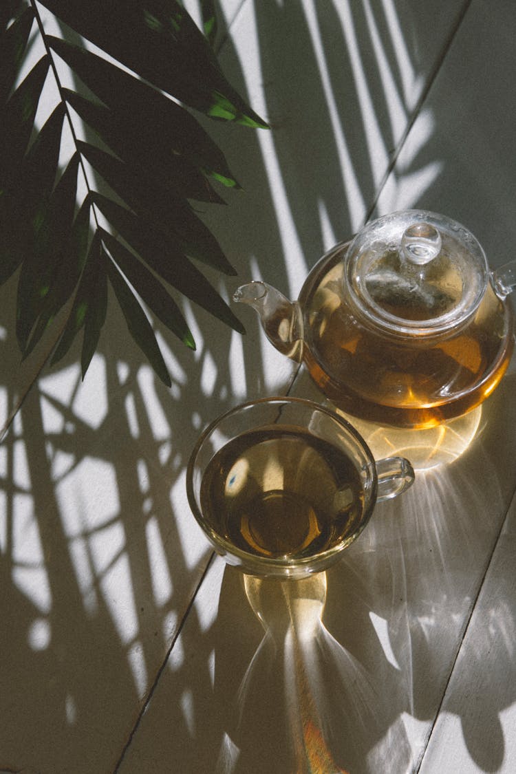 Glass Teapot And A Glass With Tea 