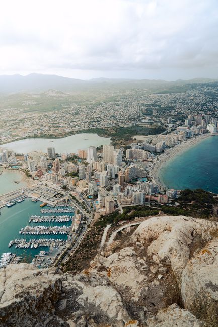 Stunning aerial shot of Calp's marina with towering skyscrapers and coastline.