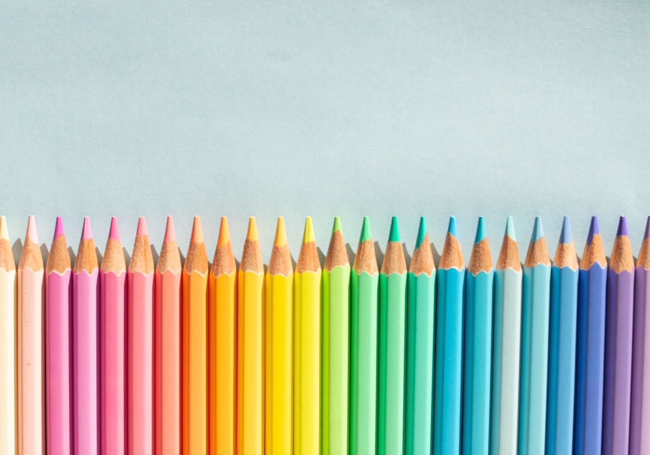 bright and colorful pencils aligned on a light background perfect for