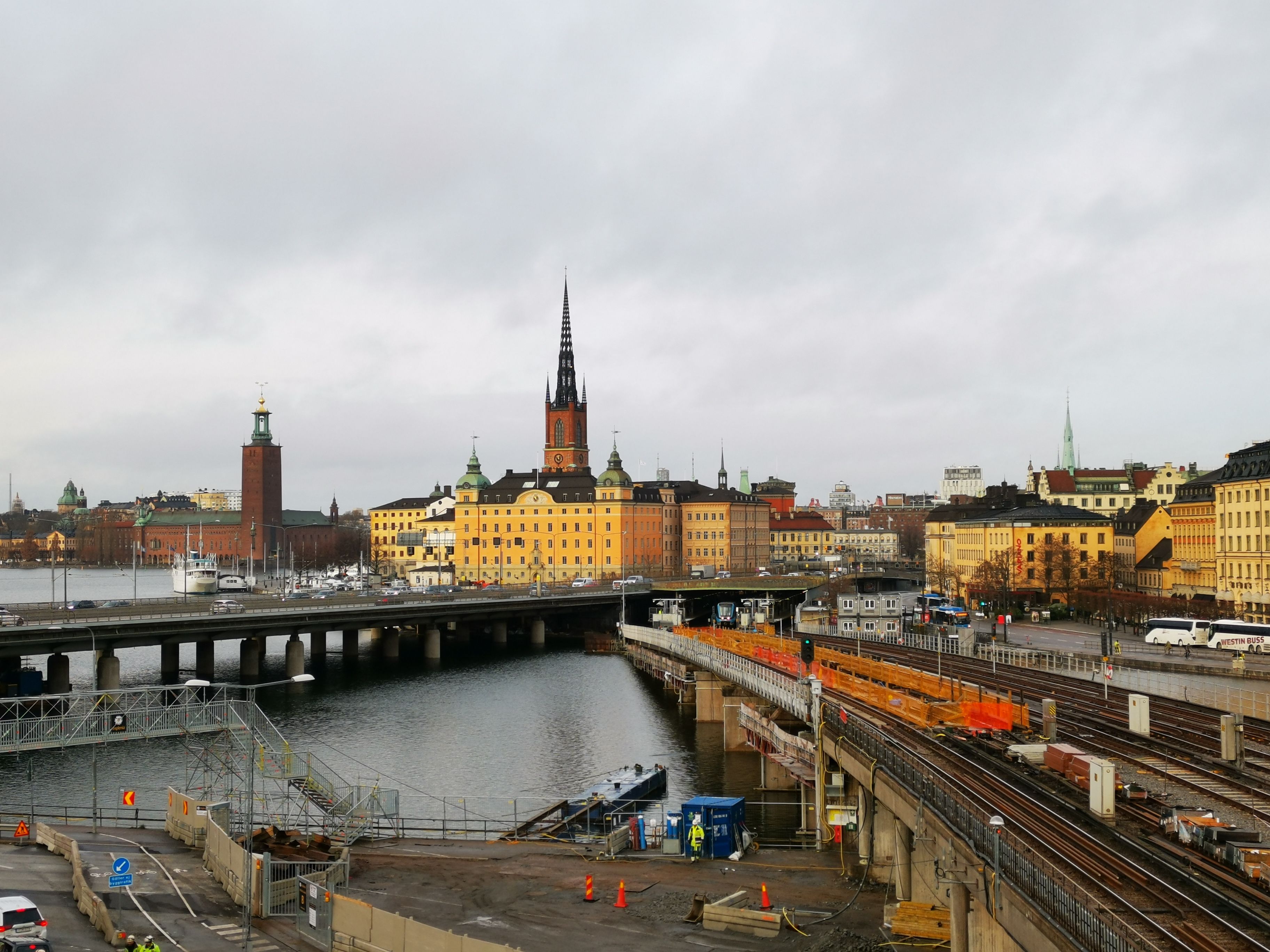 A captivating view of Stockholm's cityscape featuring historic buildings and waterways under an overcast sky.