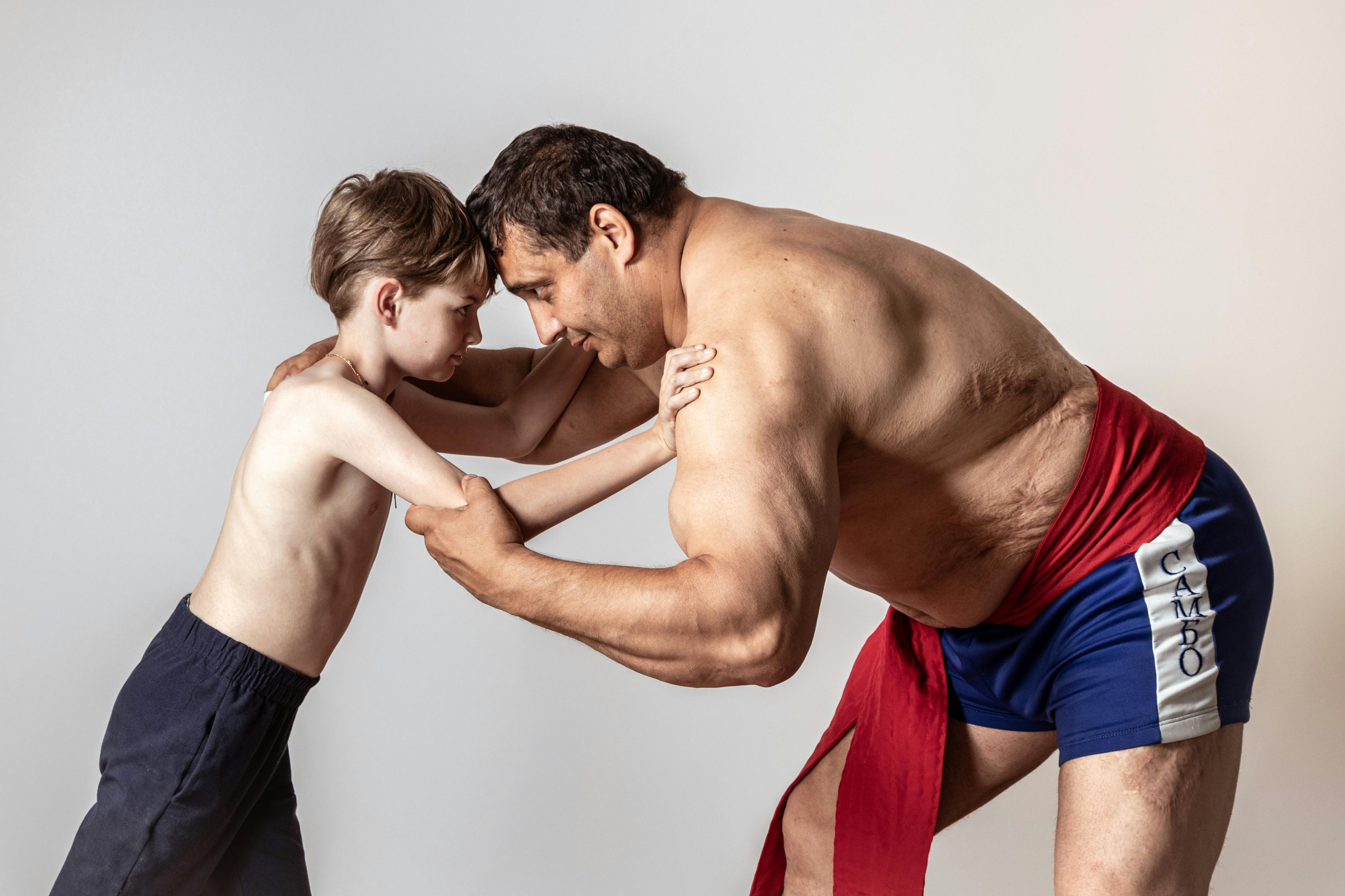 A Boy Wrestling with an Athlete · Free Stock Photo