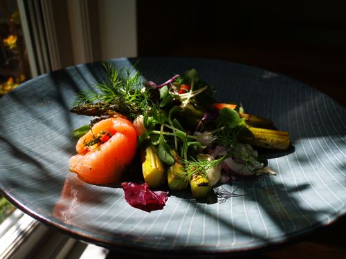 Free Elegant smoked salmon salad with asparagus and greens on a blue plate. Stock Photo