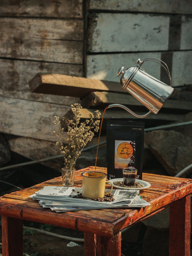 A Coffee Pot Floating In Midair While Pouring Coffee In A Cup