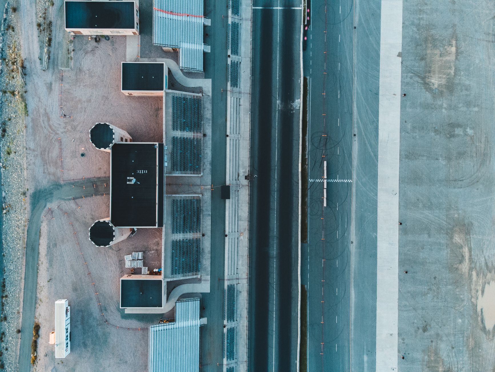 Aerial shot of an empty race track and stands from above.