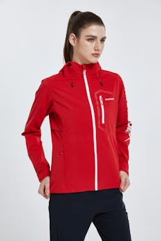 Stylish red jacket on young woman in a studio shoot, perfect for modern street fashion.