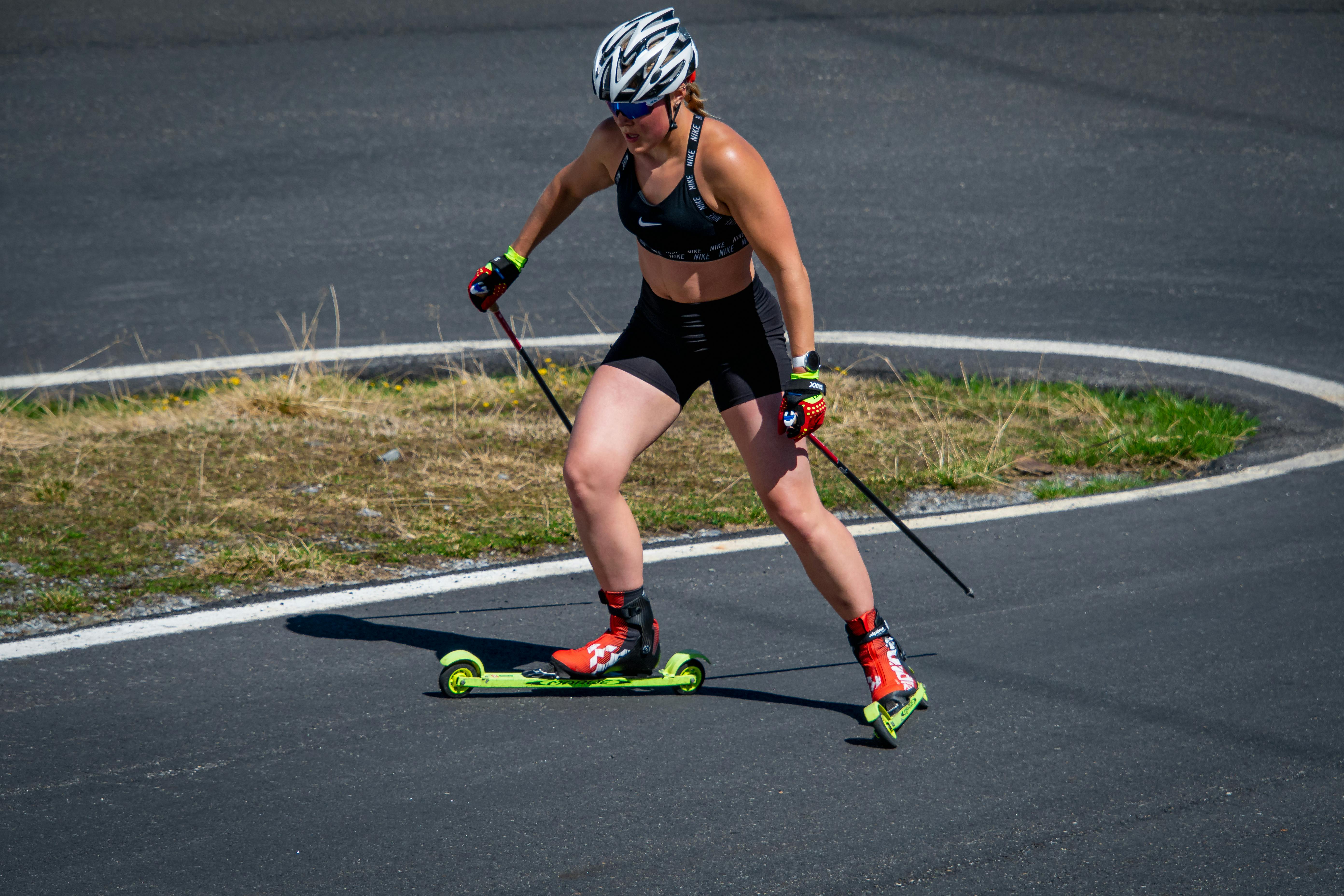 Prescription Goggle Inserts - Caucasian woman roller skiing in athletic gear on an outdoor track in Italy, displaying fitness and agility.