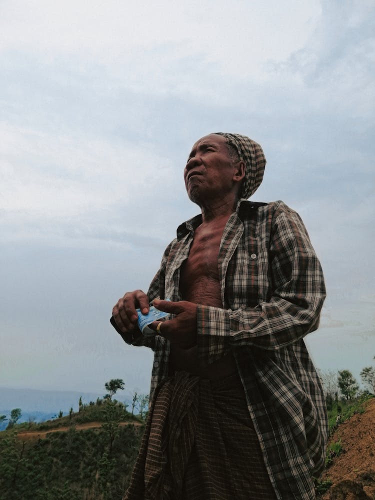 Low Angle Shot Of An Elderly Man Holding Cash