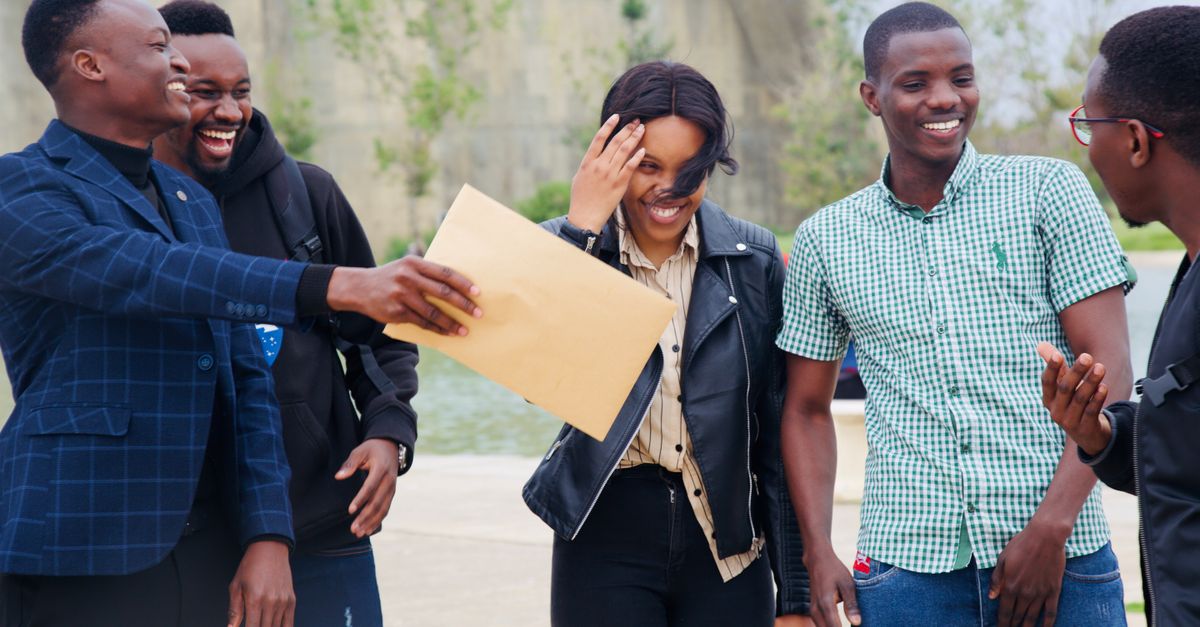 A diverse group of people laughing and talking together outside a church building