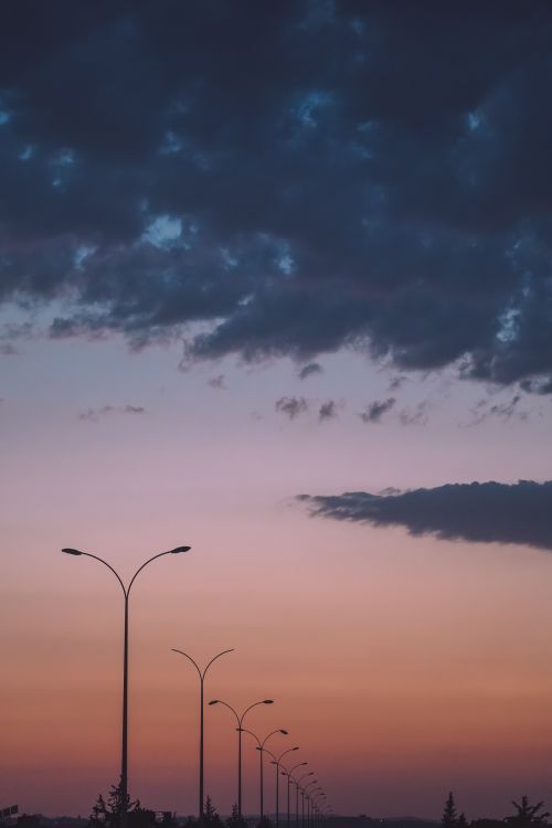 Free Beautiful sunset in Syria with streetlights silhouetted against colorful sky. Stock Photo