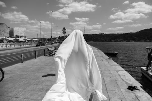 Grayscale Photo of a Person with White Cloth