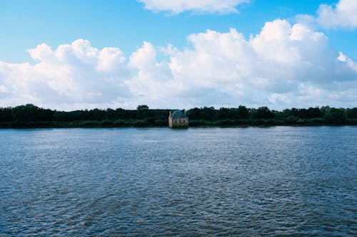 House near the Lake Under Cloudy Sky