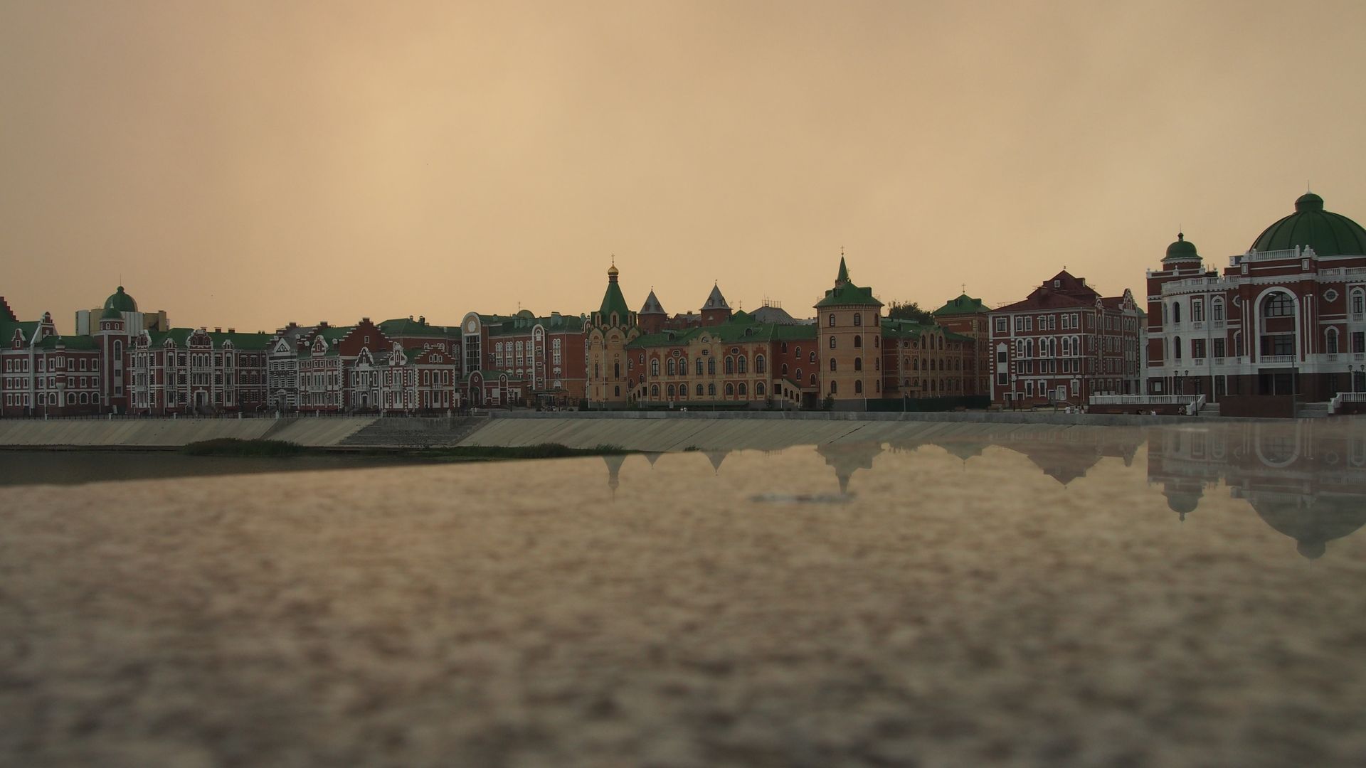 Scenic view of Yoshkar-Ola waterfront buildings at sunset along the Malaya Kokshaga River.