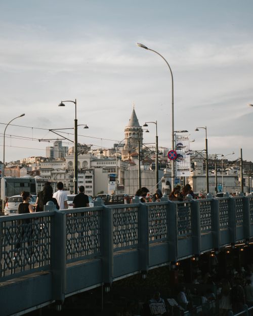 Free An urban scene with the iconic Galata Tower viewed from a busy bridge during daytime. Stock Photo