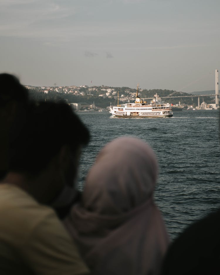 People Watching A Ferry Boat