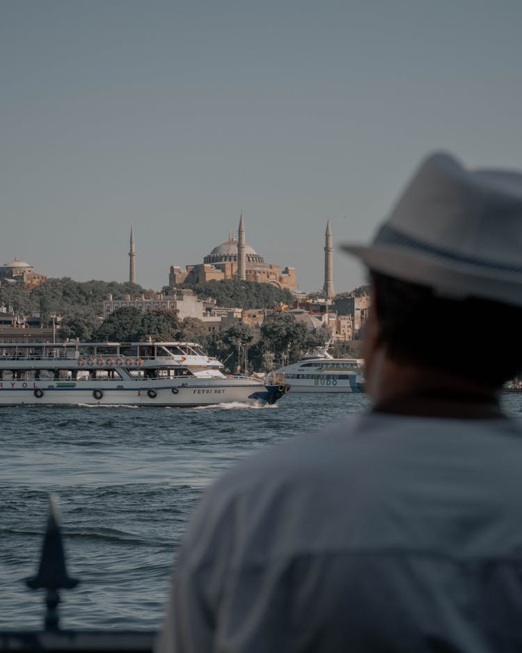 Back View Of A Man In Hat Looking At Byzantine Architecture