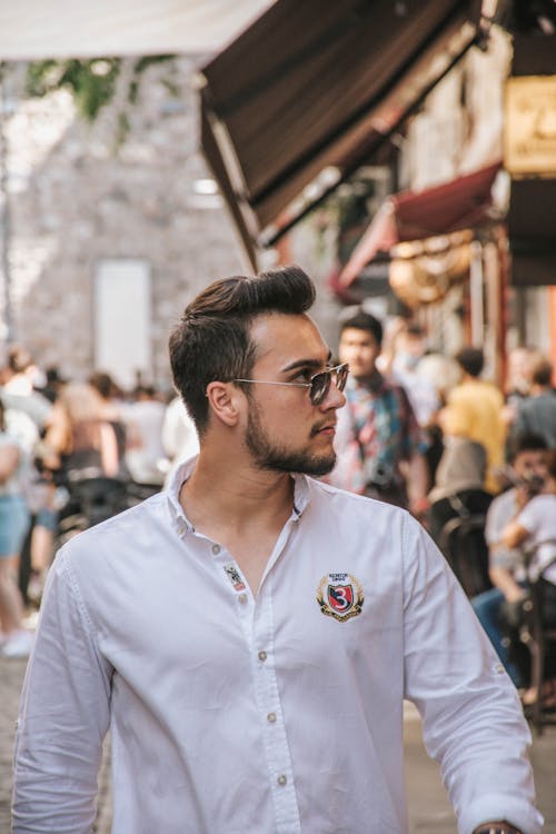 A Man in a White Button Down Shirt Looking SIdeways