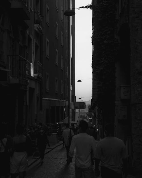Grayscale Photo of People Walking in the Street