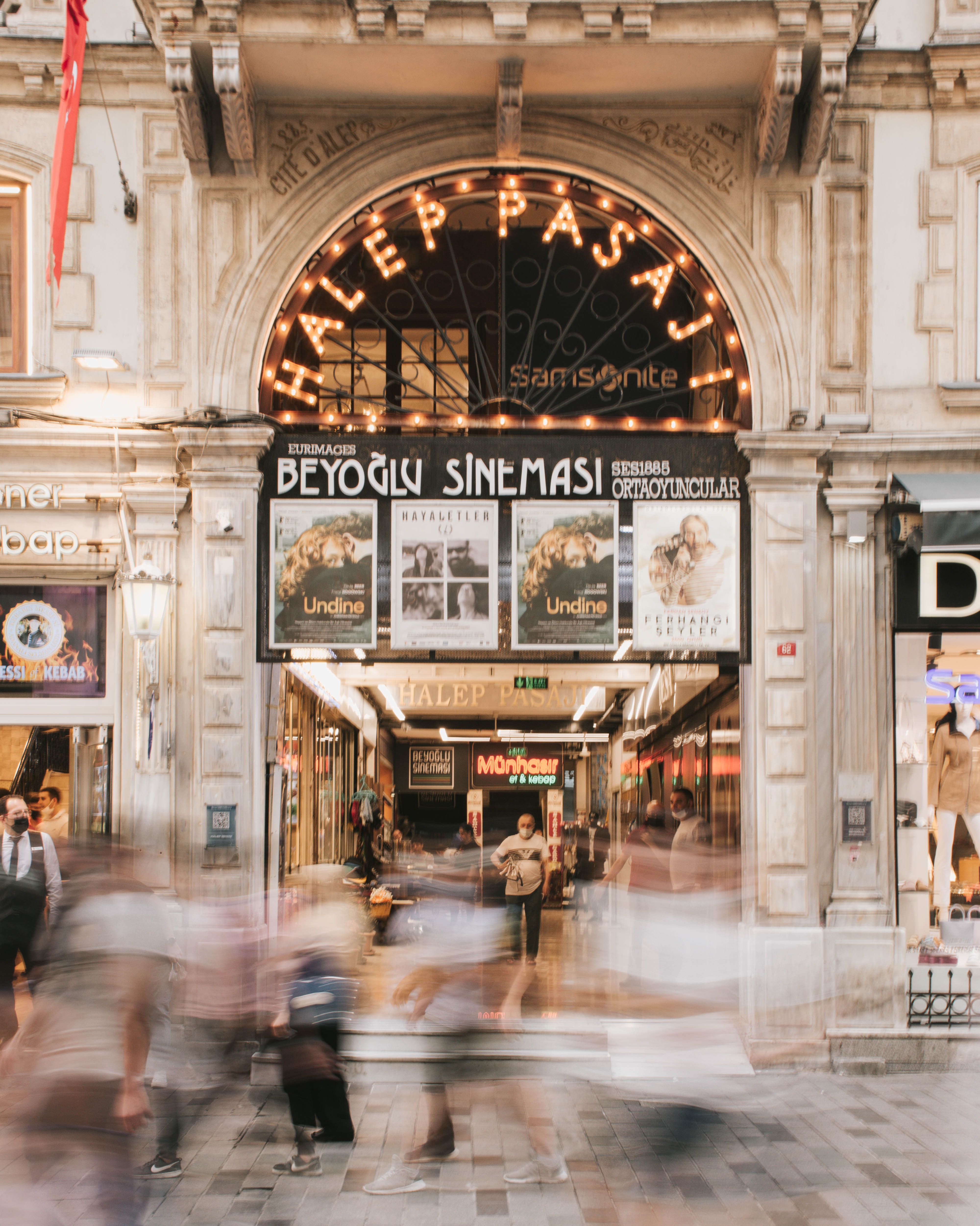 Long exposure of Beyoglu Cinema entrance in Istanbul capturing dynamic pedestrian movement.