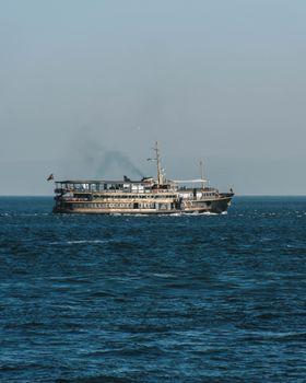 A historical ferry named La Vepeur Magique sailing under a clear sky on the ocean.