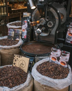 Close-up of coffee beans in sacks with traditional grinder in cafe setting, perfect for coffee shop visuals.