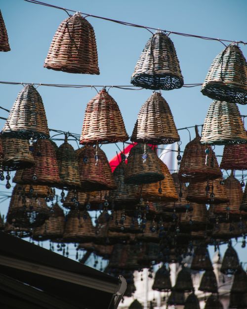 Free Wicker baskets hanging in a sunny outdoor setting, creating a cultural ambiance. Stock Photo