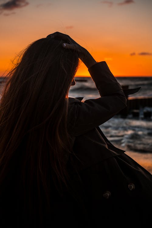 Free Back View of a Woman on Beach during Sunset Stock Photo