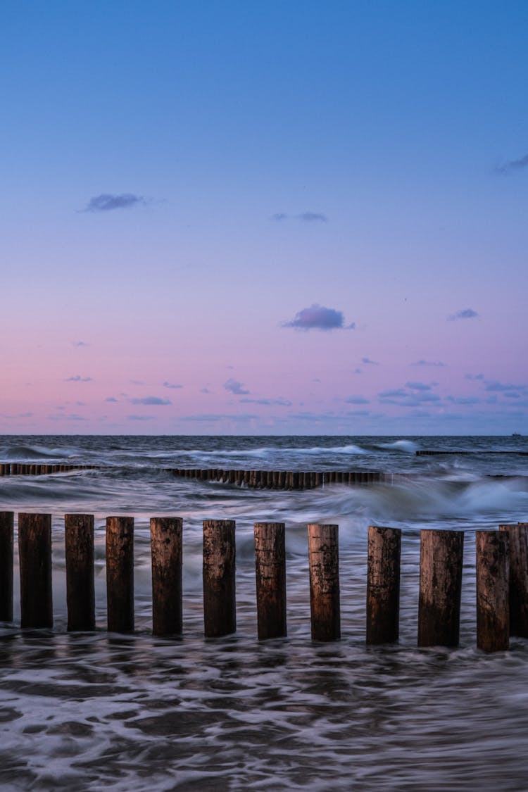 Wooden Wave Breaker At Sunset