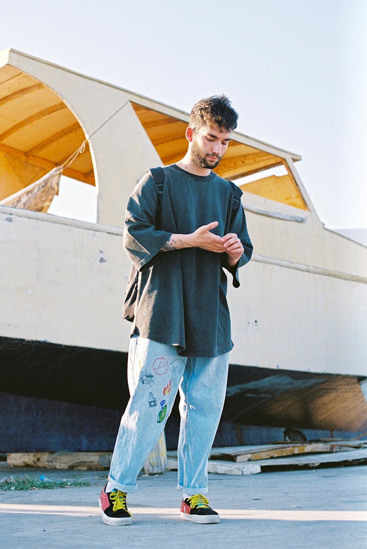 A Man In Black Oversize Shirt Standing