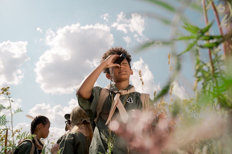 A Boy Using A Spotting Scope