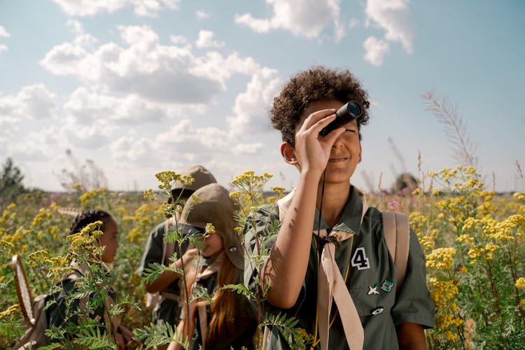 A Boy Using A Spotting Scope