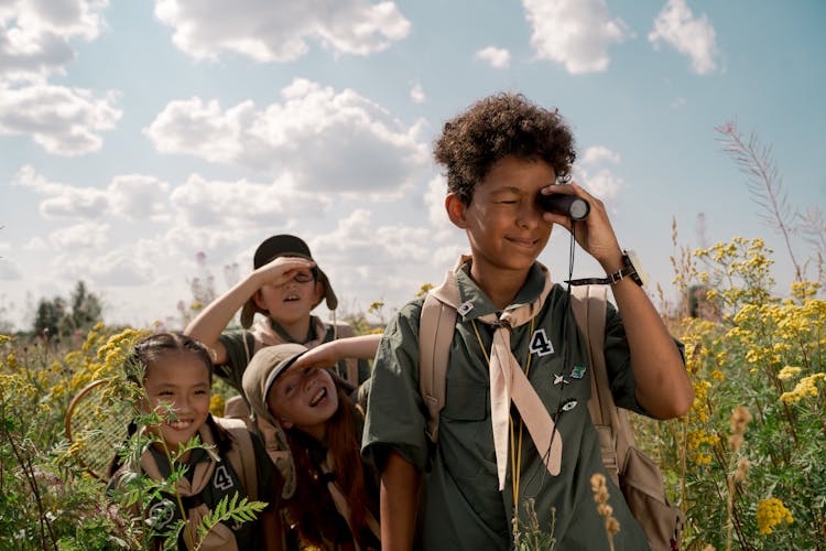 A Boy Using A Spotting Scope