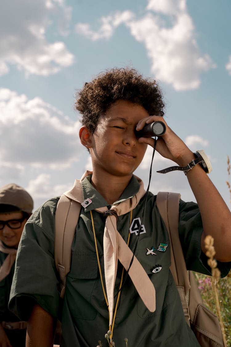 A Boy Using A Spotting Scope