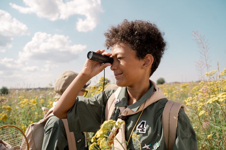 A Boy Using A Spotting Scope