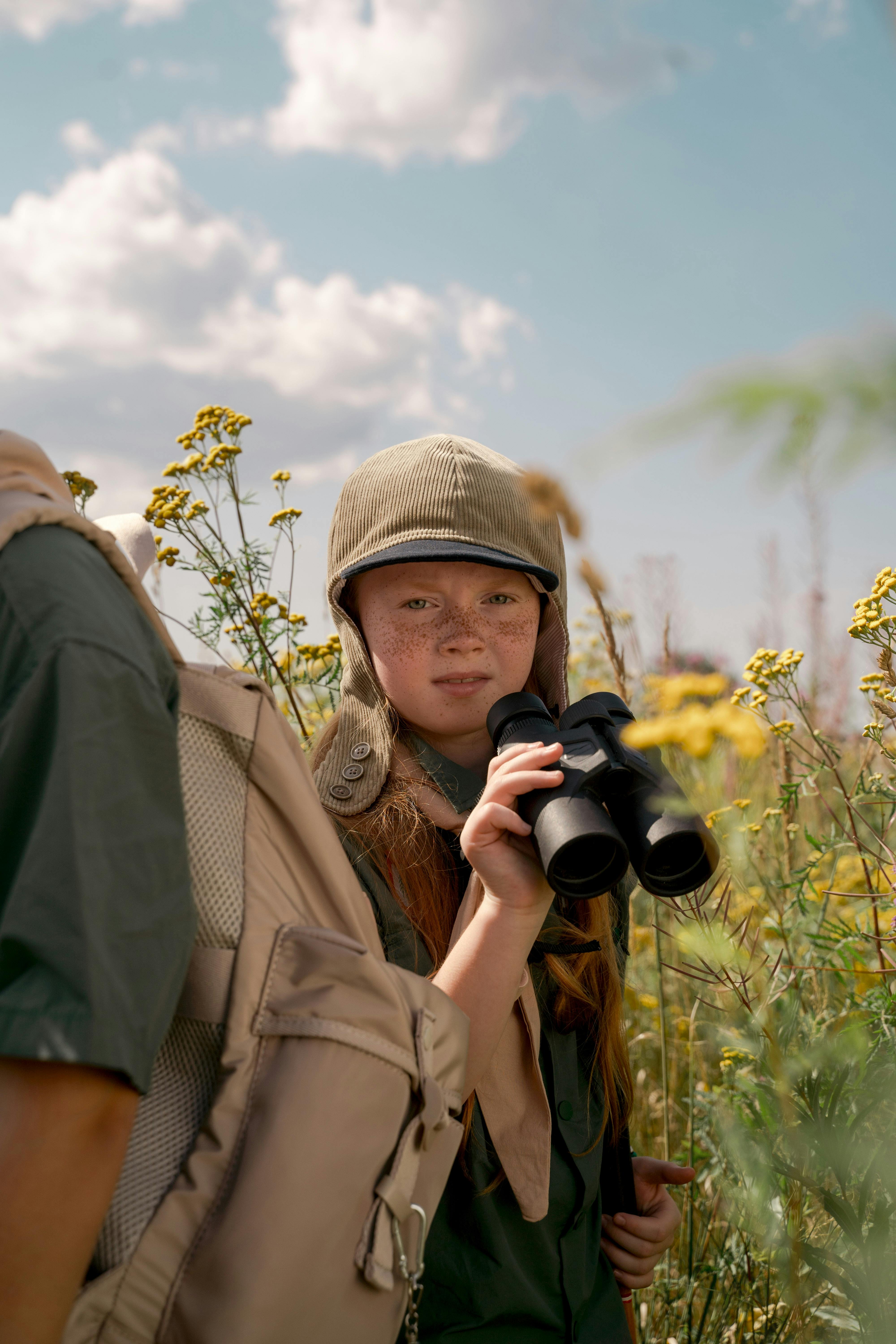 a girl using binoculars