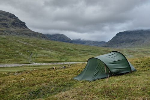 Free A Green Tent Near the Mountains  Stock Photo