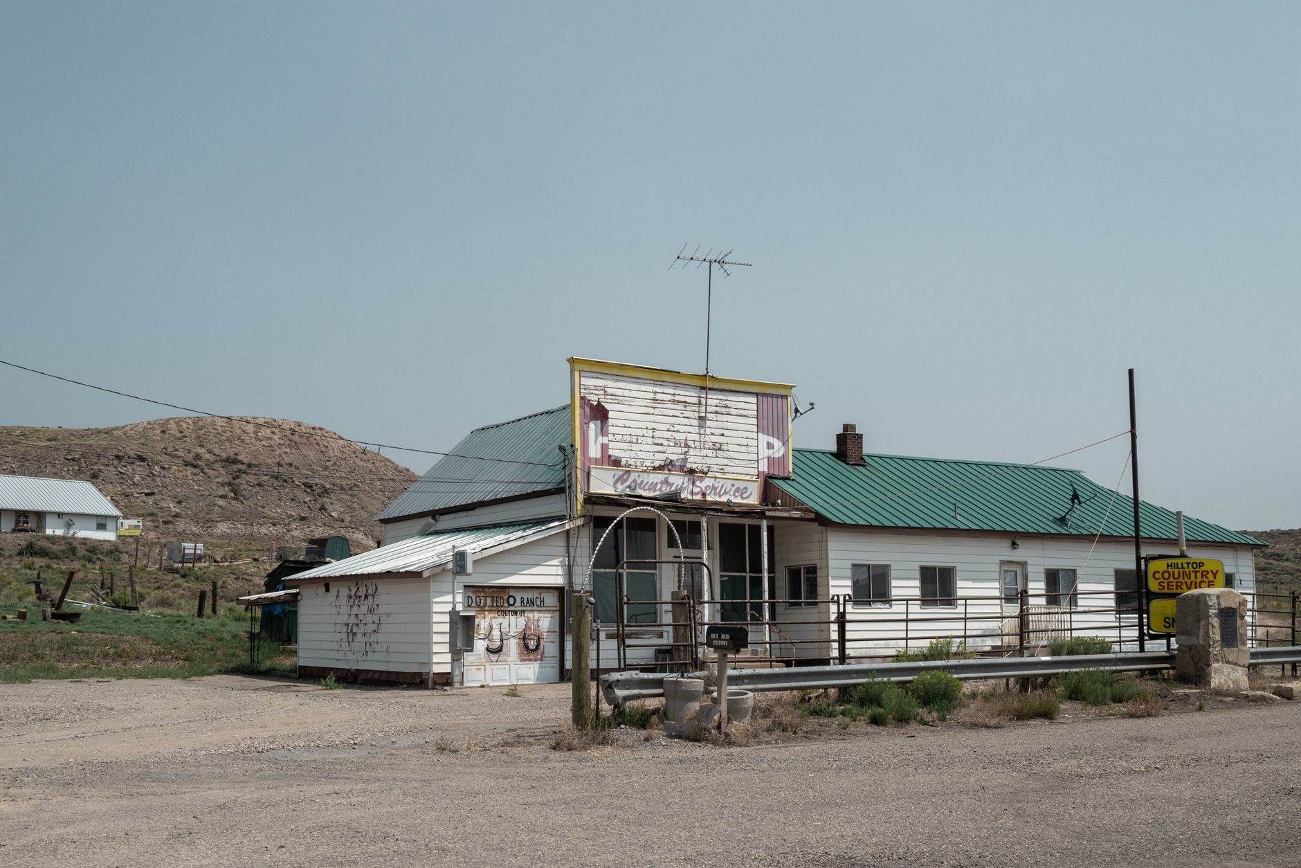 Abandoned gas station in Utah's desert with a blue sky backdrop.