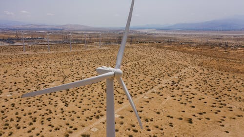 A White Windmill on Brown Field in Close-up Shot