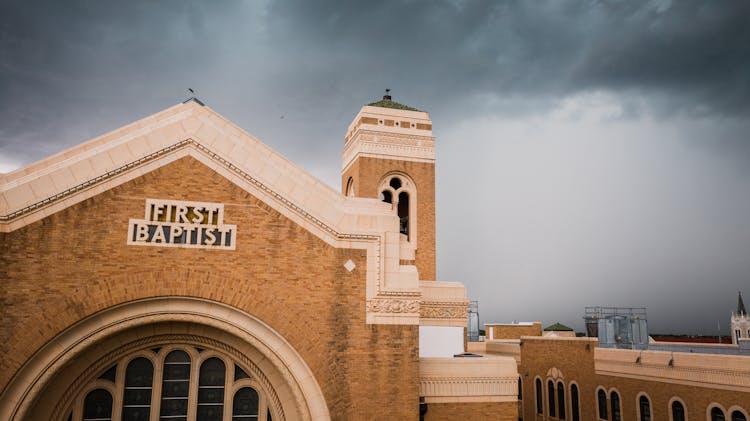 A First Baptist Church Under Gray Clouds