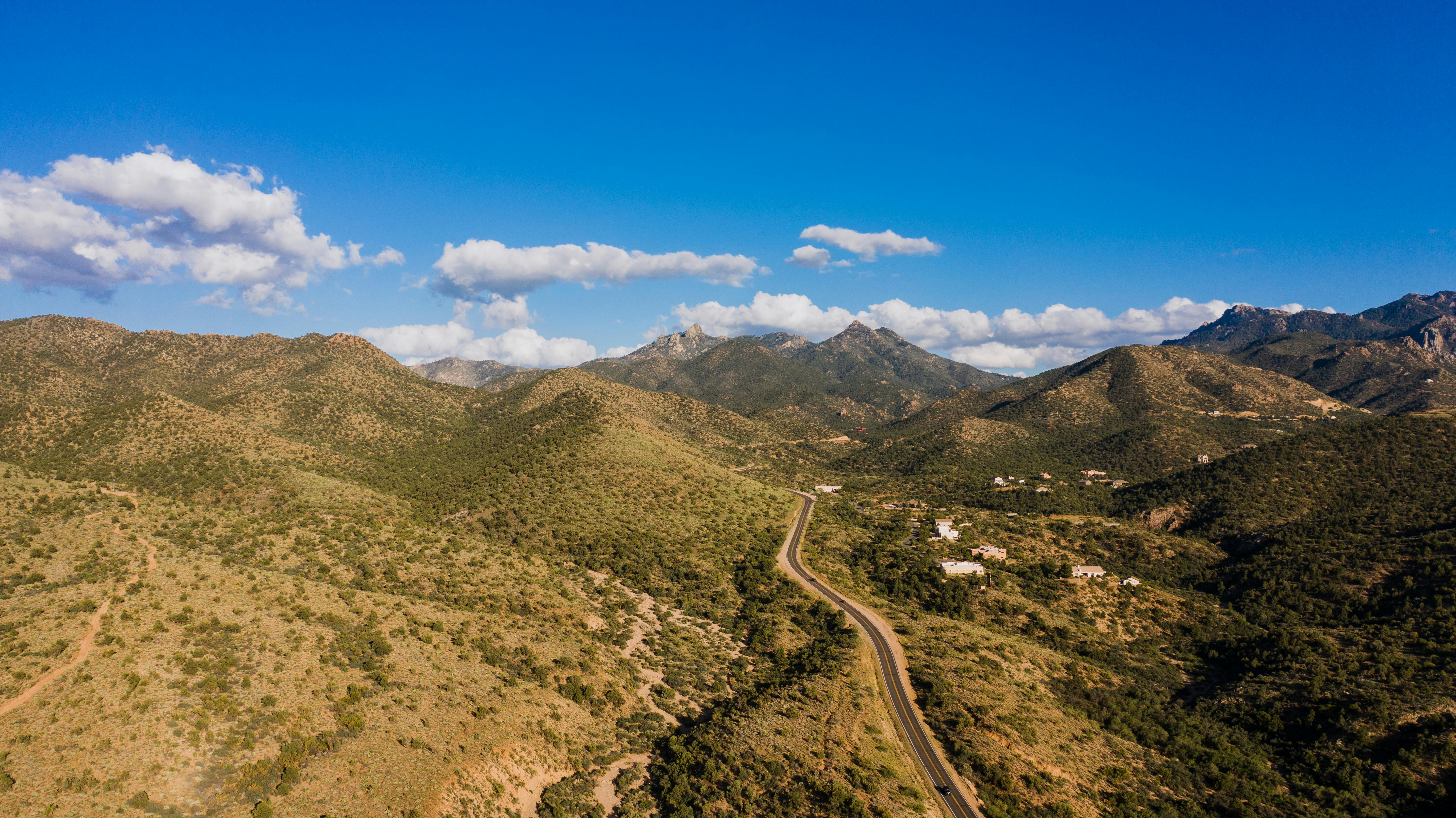 A breathtaking aerial view showcasing a mountain range under a clear blue sky.