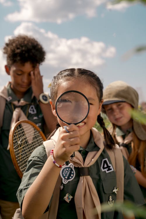 A Braided Girl Holding a Magnifier 