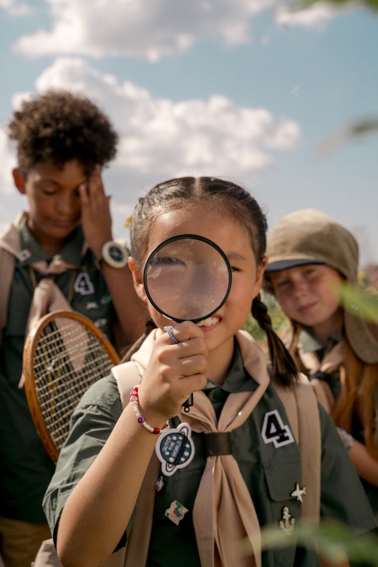 A Braided Girl Holding A Magnifier 