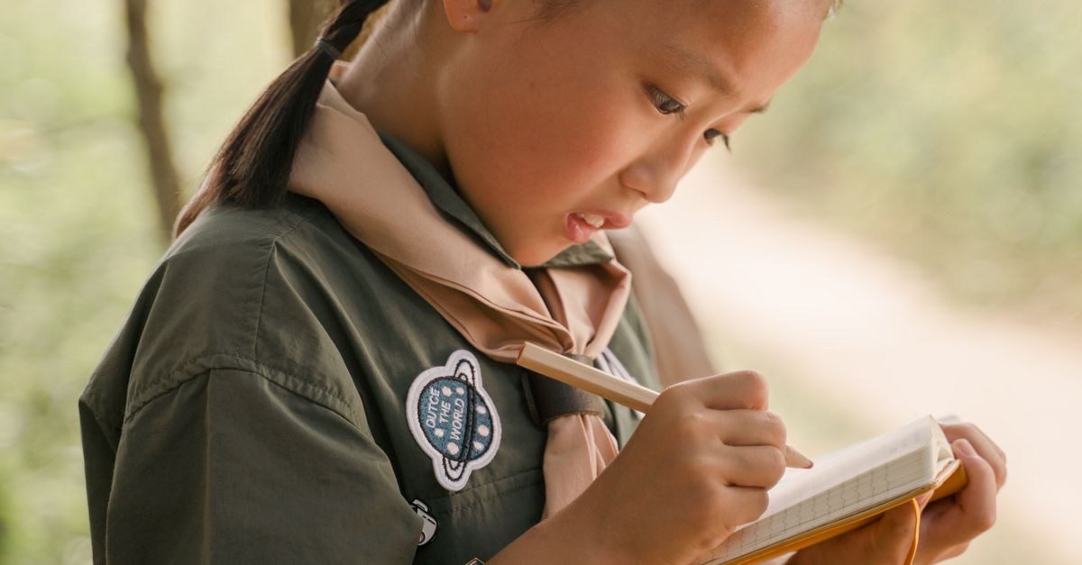 Scout Writing A Girl Scout Taking Notes · Free Stock Photo