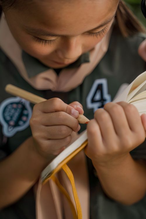 Scout Writing A Girl Writing in the Notebook · Free Stock Photo