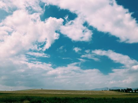 Peaceful and idyllic countryside scene with clouds over a field in Afyonkarahisar, Türkiye.