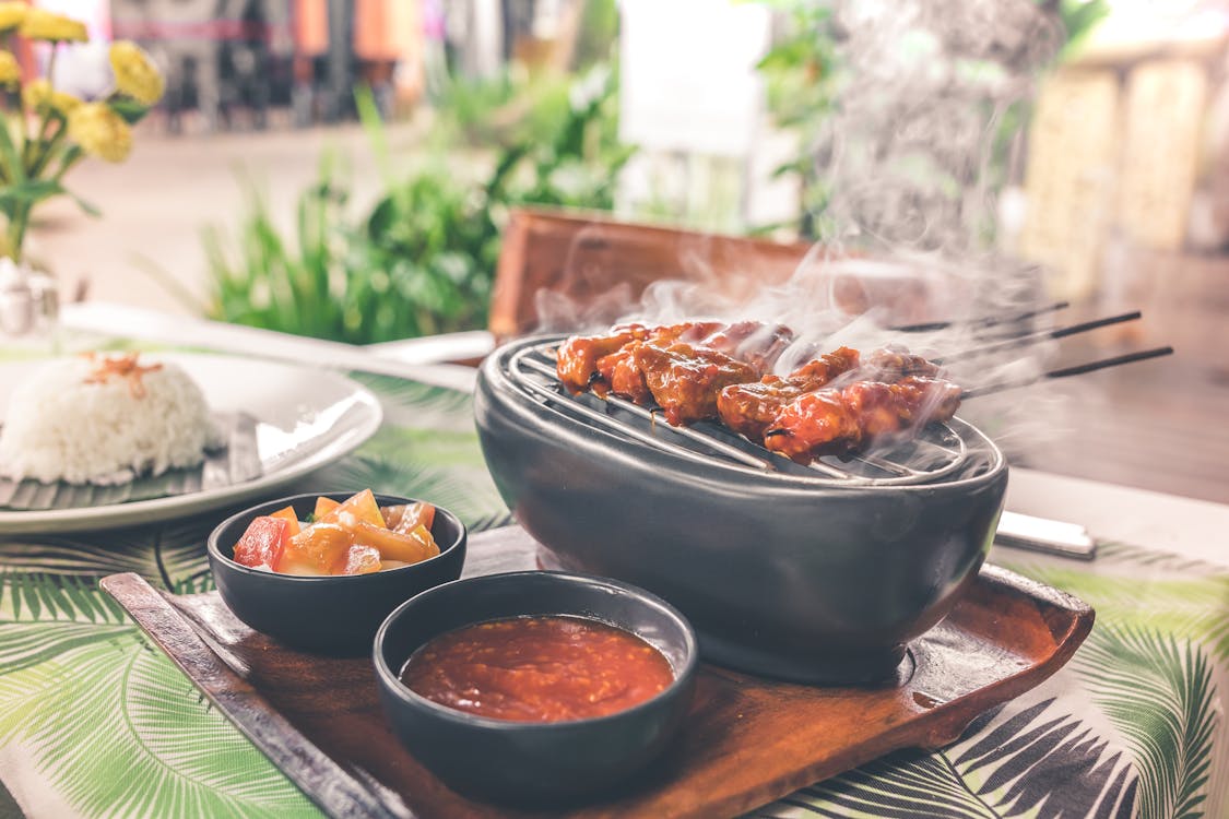 Free Barbecue on Grill With Sauce Platter Stock Photo